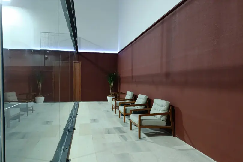 Armchairs along the court glass