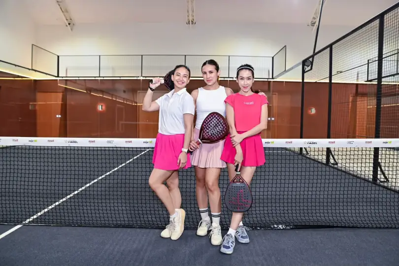Three players posing at the net